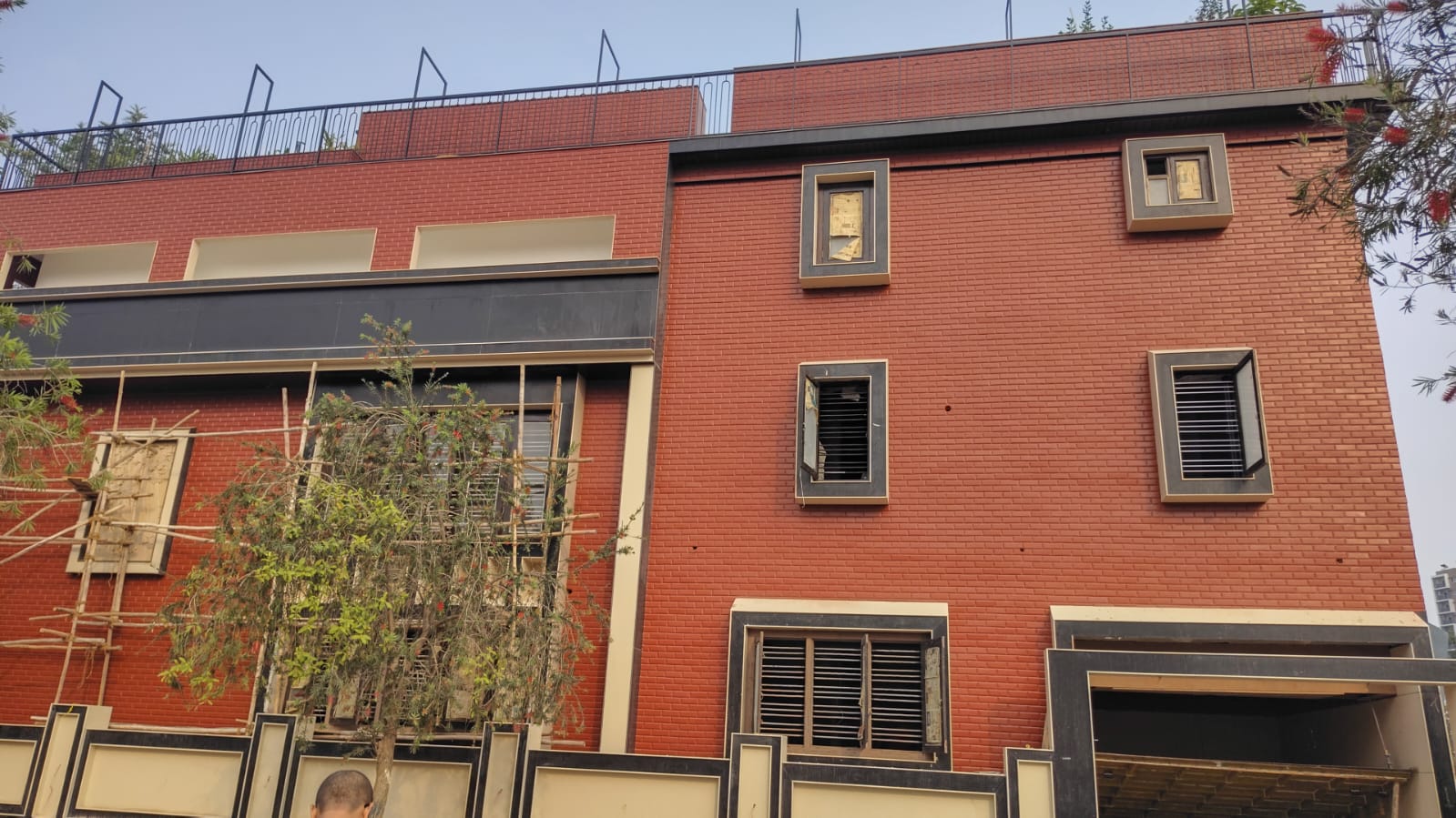 Completed red-brick residential building by HITNAL INFRA